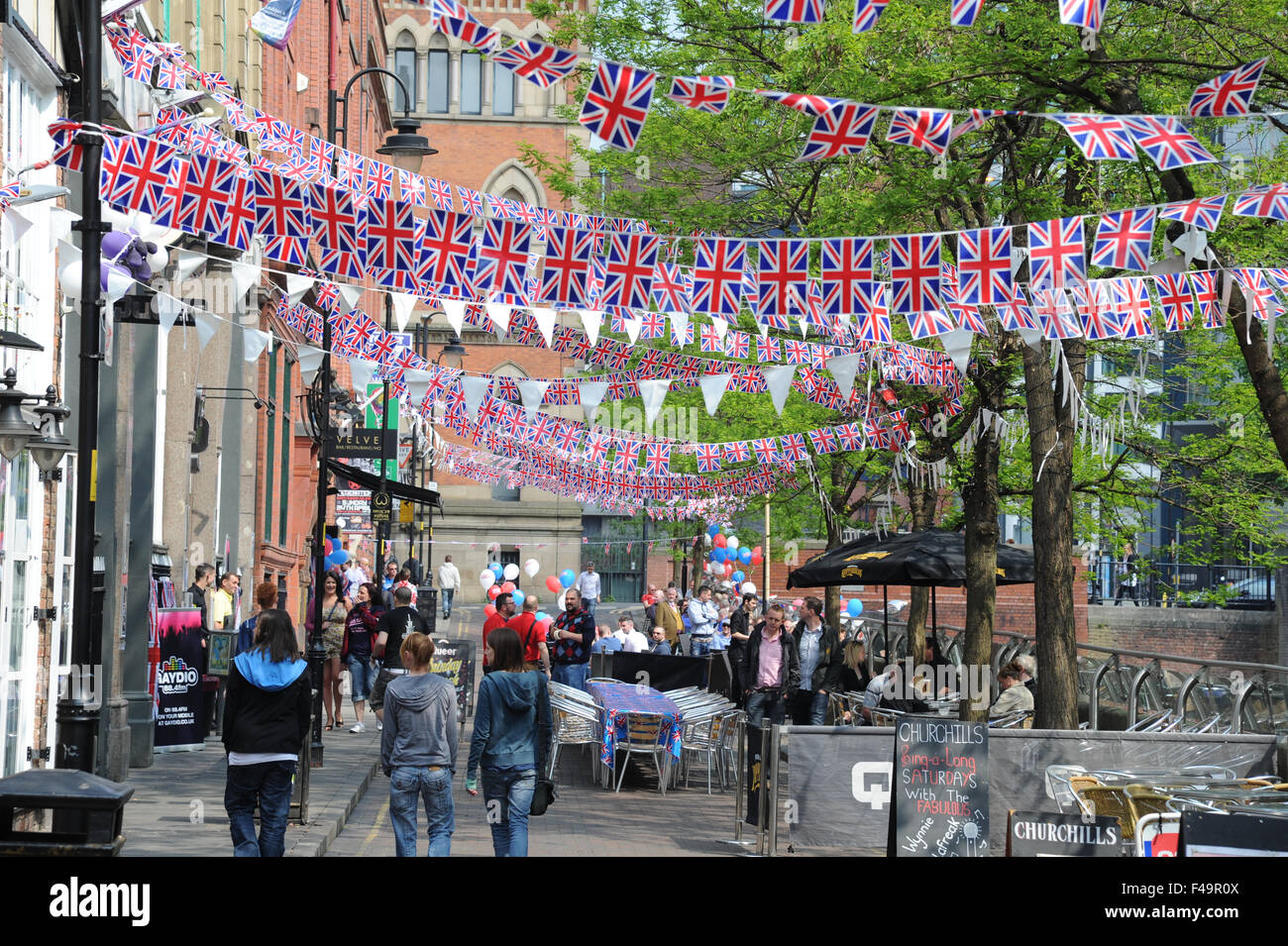 Party bunting on Canal Street in the heart of Manchester's Gay village to celebrate the wedding of William and Kate. Stock Photo