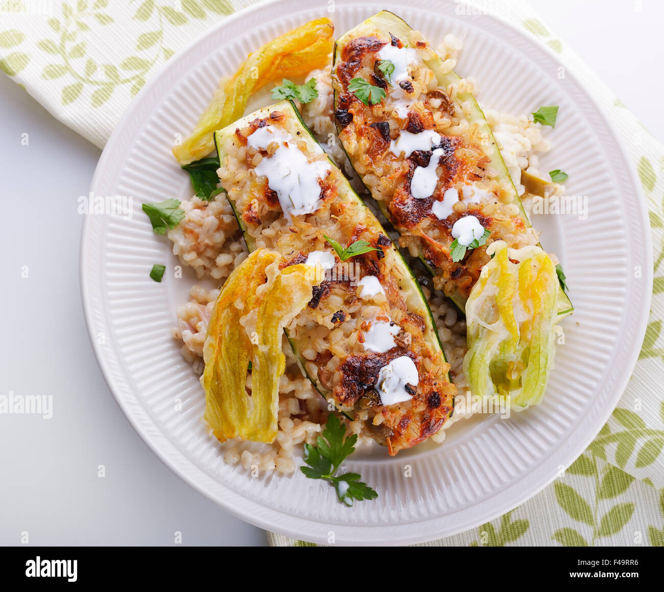 Mozzarella and Barley Stuffed Zucchini with Crispy Blossoms Stock Photo