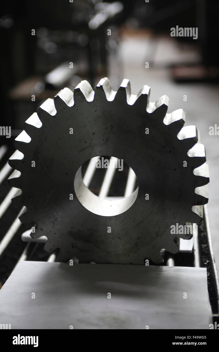 metal tooth wheel, cogwheel, pinion gear, a job for lathe operator, element for design pattern Stock Photo