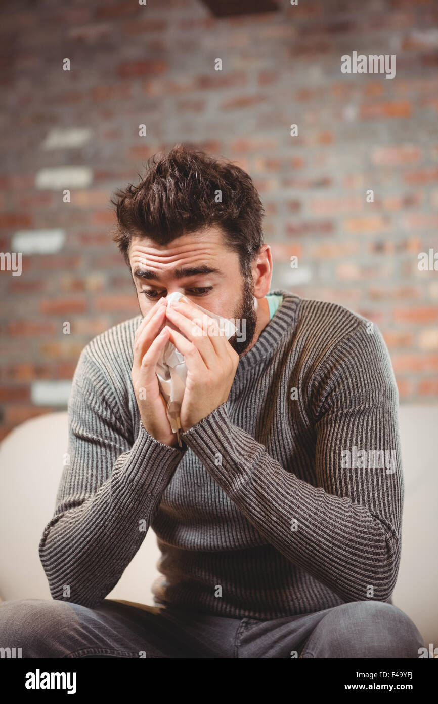 SIck Man blowing his nose Stock Photo