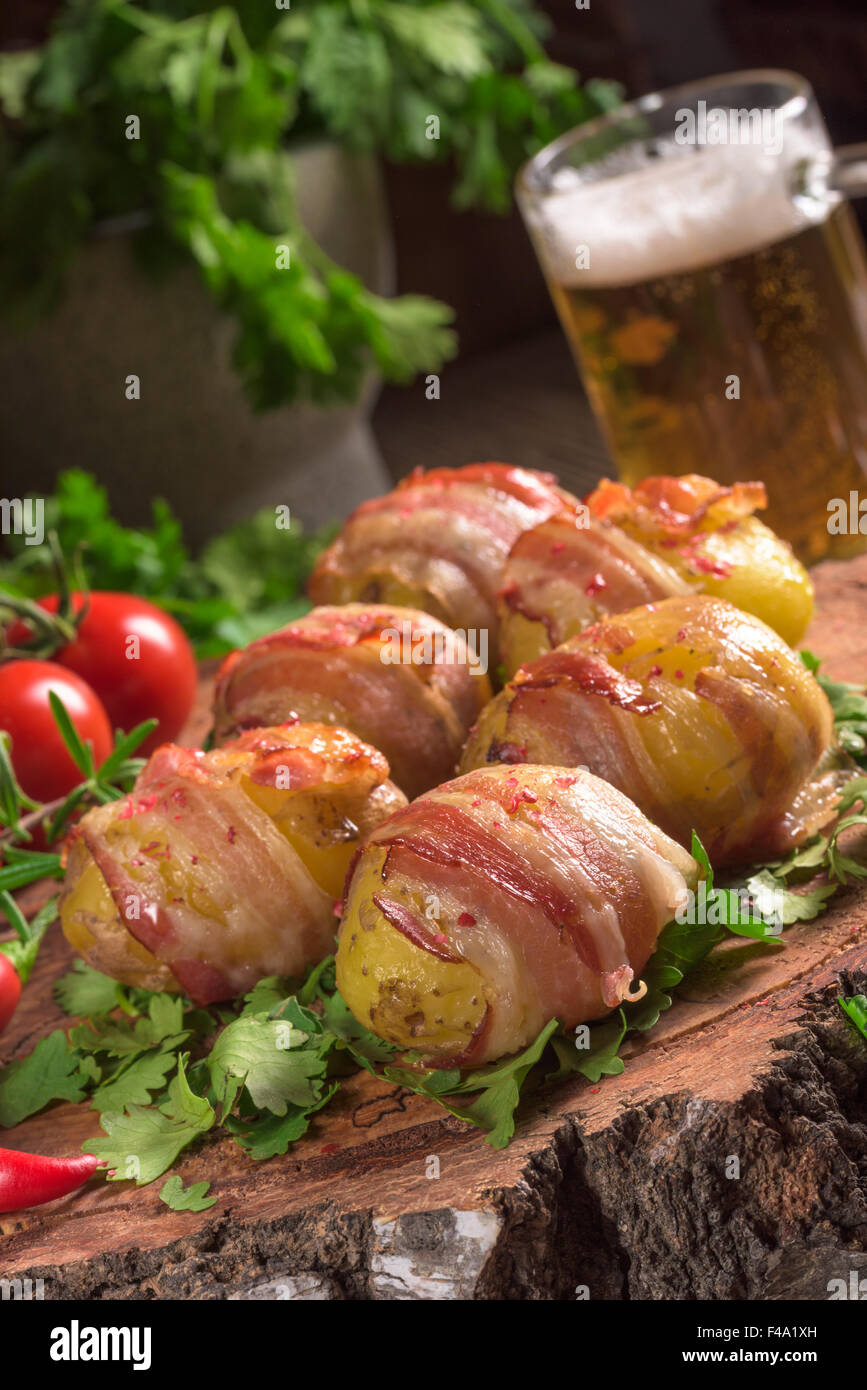 Baked potatoes wrapped in ham Stock Photo Alamy