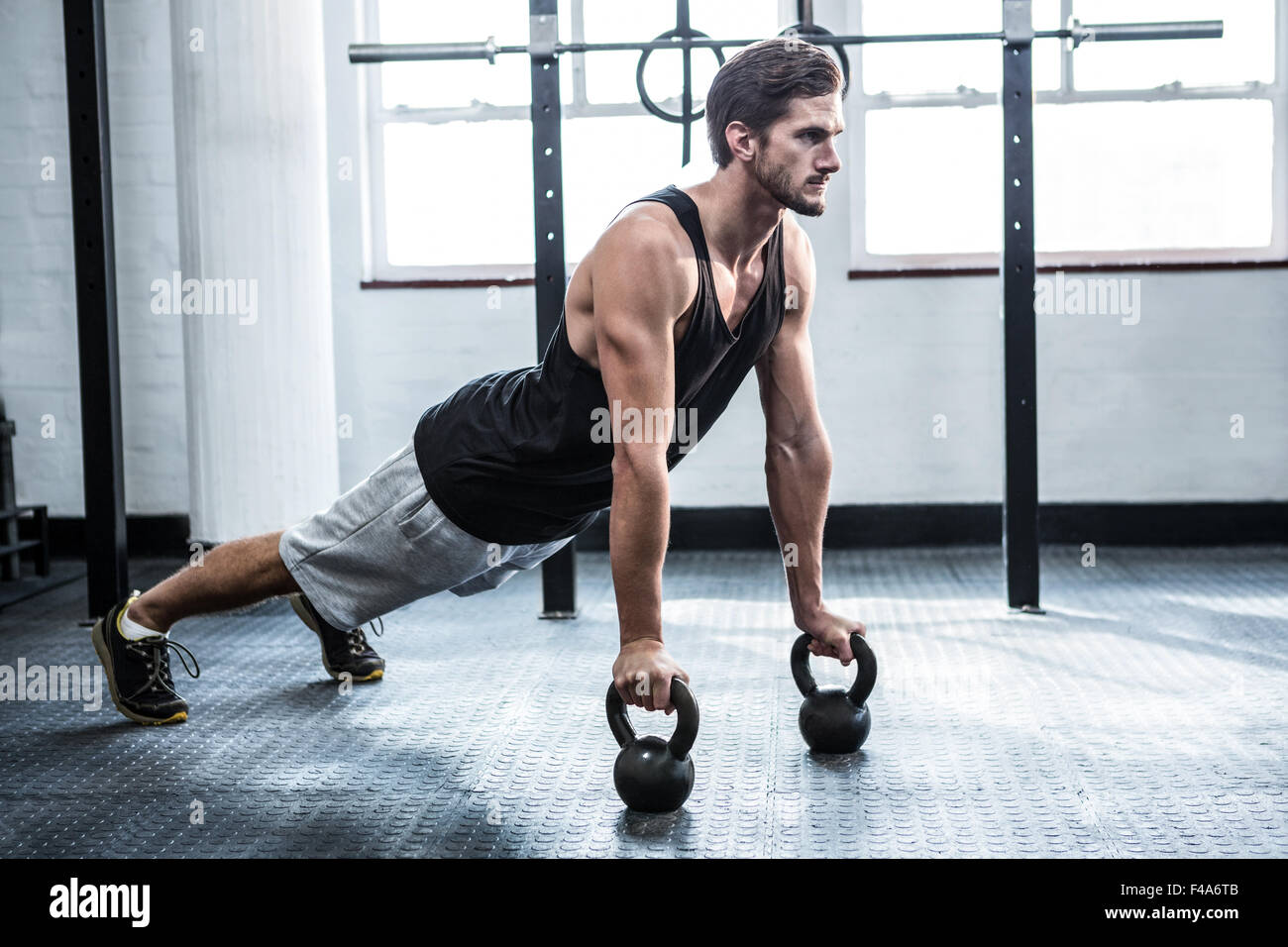 Fit man working out with kettlebells Stock Photo