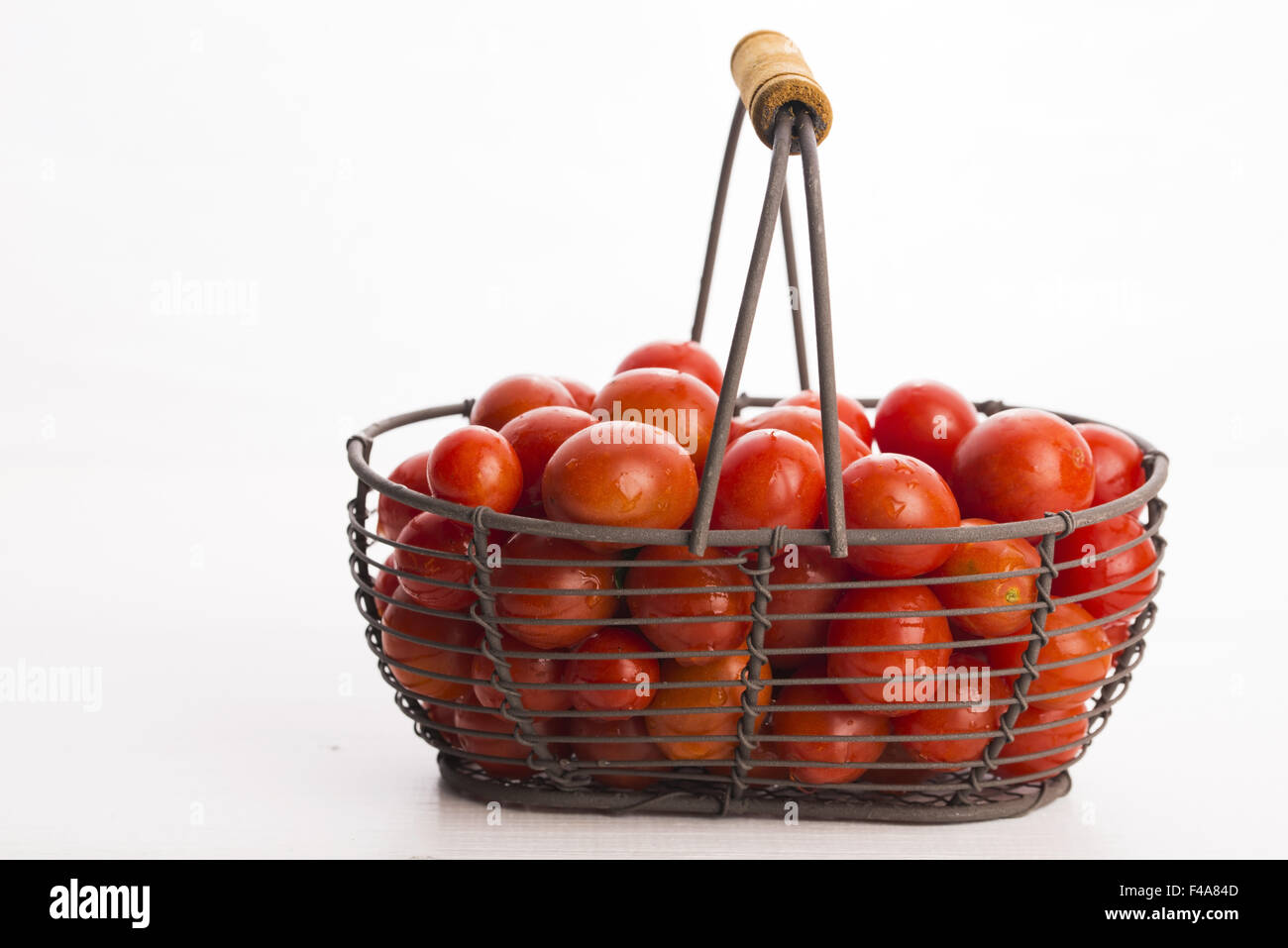 Cherry tomatoes in basket Stock Photo - Alamy