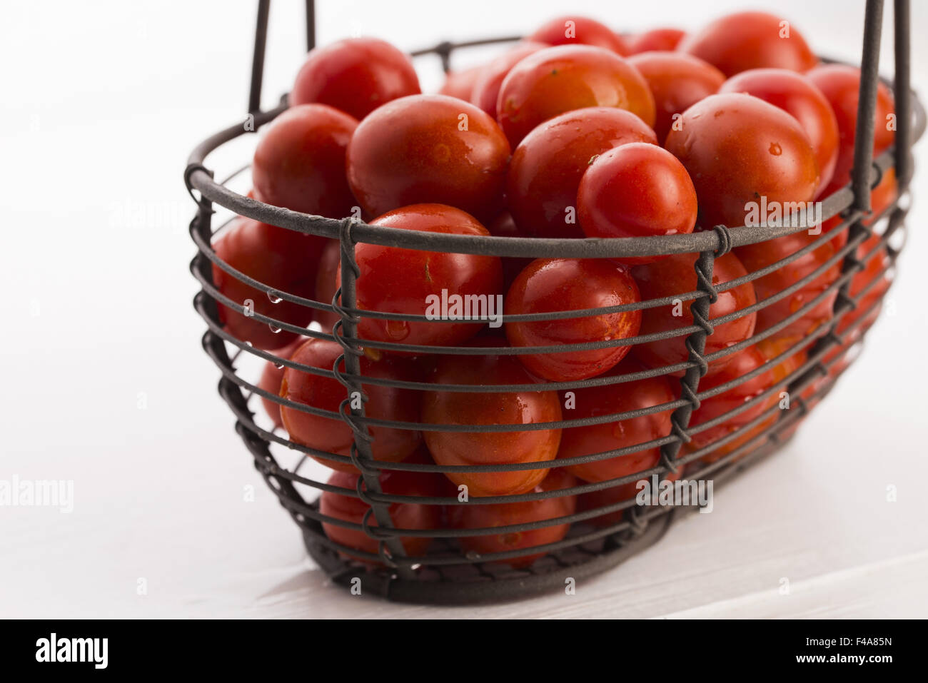 Cherry tomatoes in basket Stock Photo - Alamy