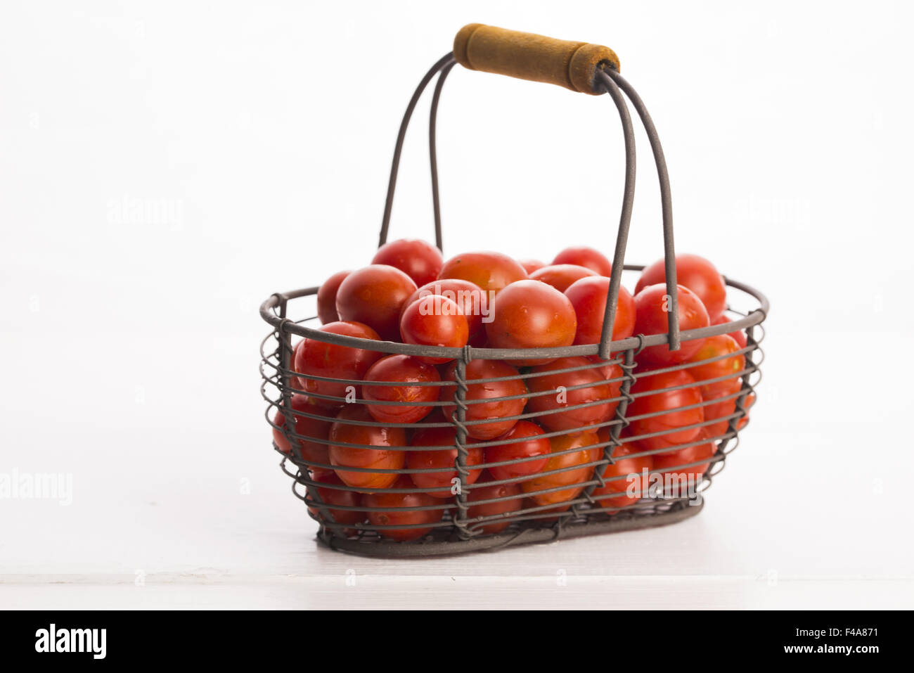 Cherry tomatoes in basket Stock Photo - Alamy