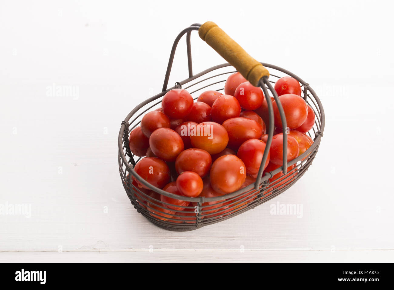 Cherry tomatoes in basket Stock Photo - Alamy