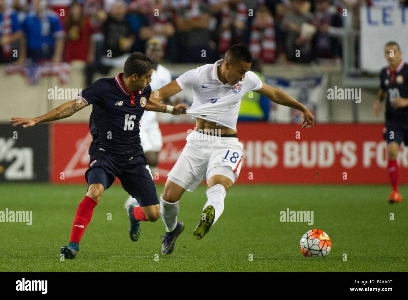 October 13, 2015: Costa Rica defender Christian Gamboa (16) grabs and pulls on USA forward Bobby Wood (18) as they battle for the ball during The USA Men's National Team vs. Costa Rica Men's National Team- international friendly at Red Bull Arena - Harrison, NJ. Costa Rica defeated The US Men's National Team 1-0. Mandatory Credit: Kostas Lymperopoulos/Cal Sport Media Stock Photo
