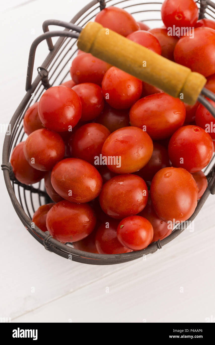 Cherry tomatoes in basket Stock Photo - Alamy
