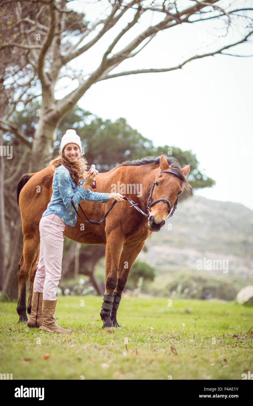 Young woman with her horse taking photo Stock Photo Alamy