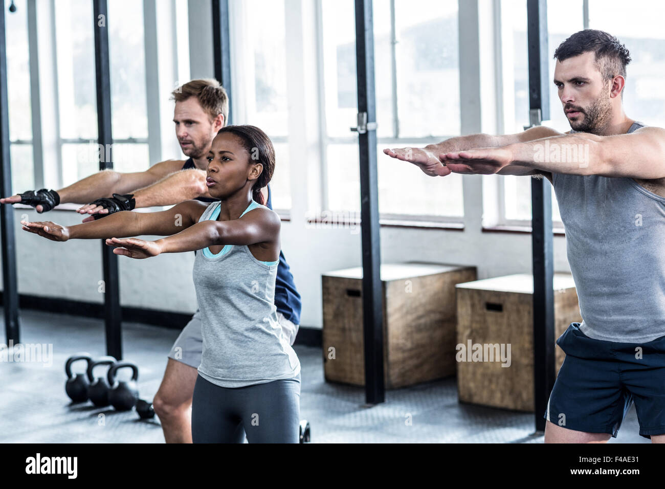 Three fit athletes stretching together Stock Photo Alamy