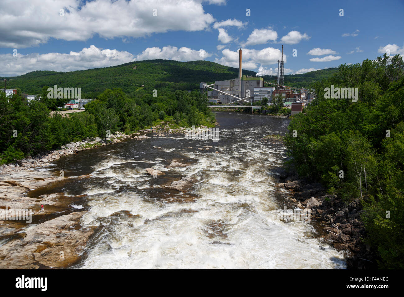 Rumford pulp mill and paper mill situated on the Androscoggin River seen from a bridge over the river. Maine June 2015 Stock Photo