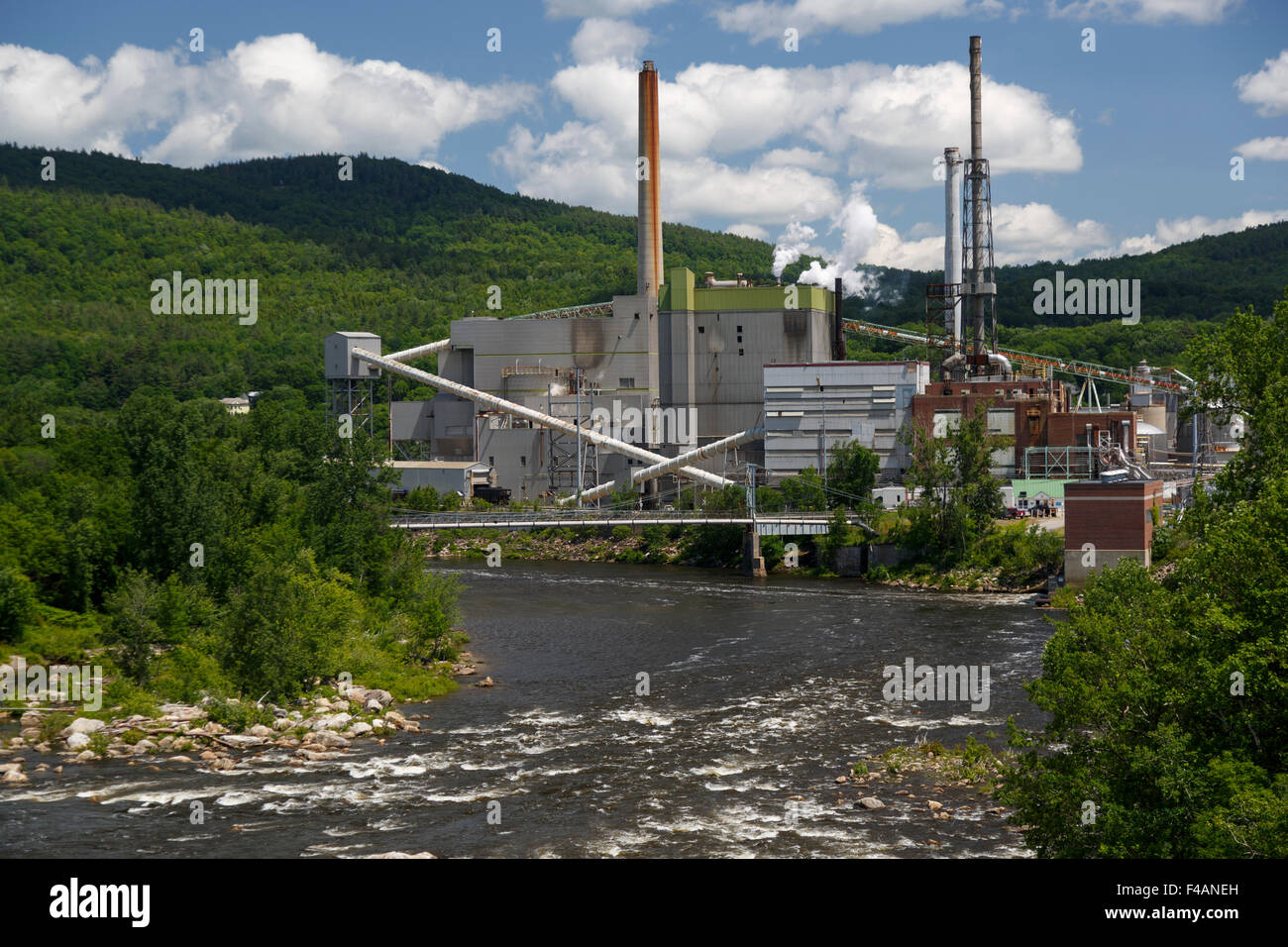 Rumford pulp mill and paper mill situated on the Androscoggin River seen from a bridge over the river. Maine USA June 2015 Stock Photo