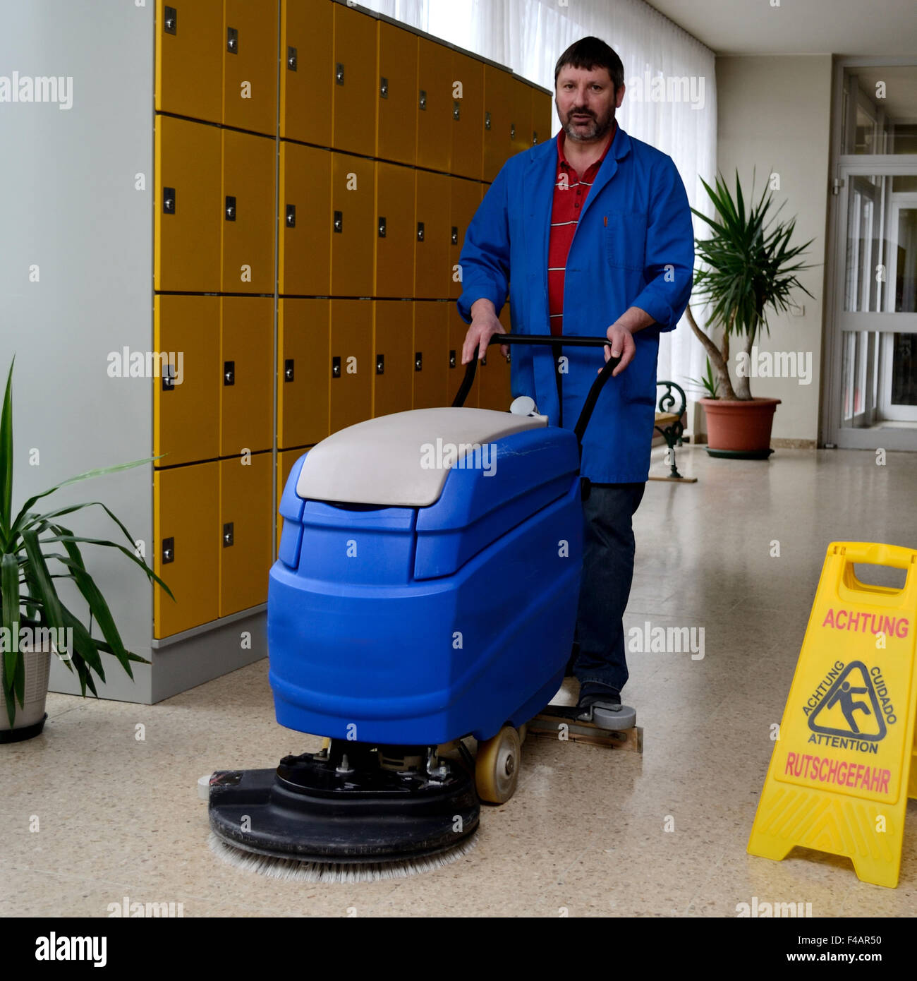 School caretaker with cleaning machine Stock Photo