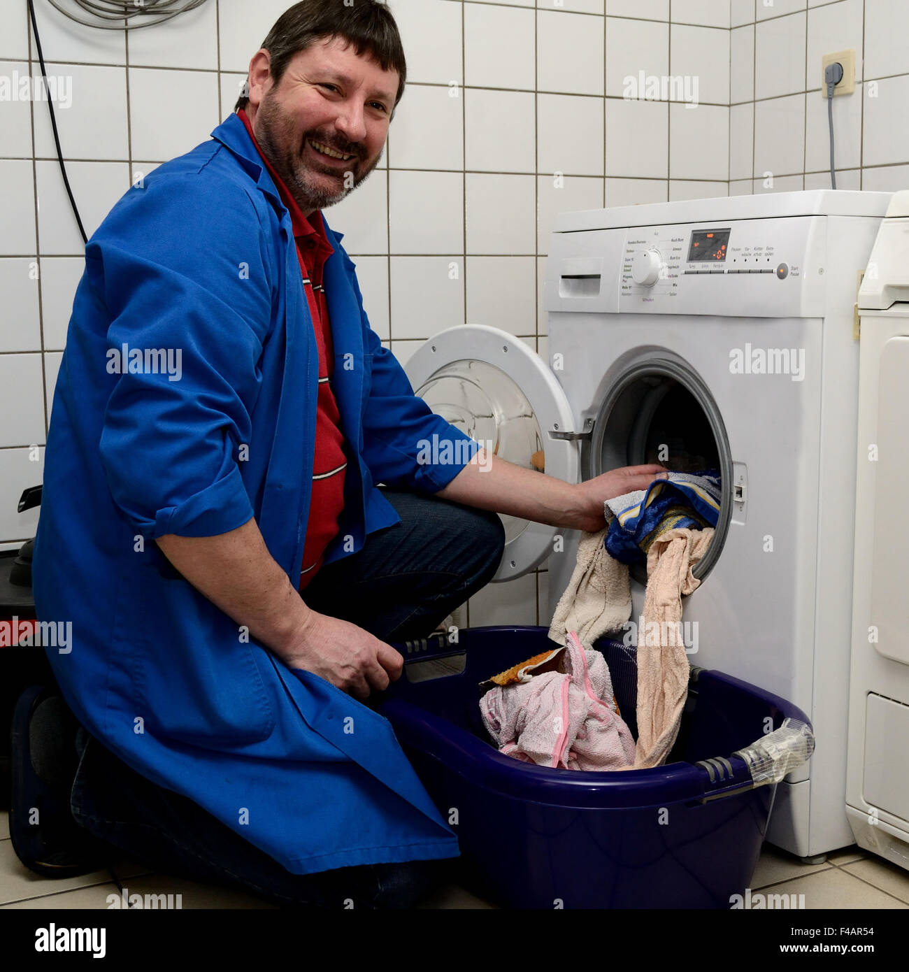 caretaker with the clothes washer Stock Photo