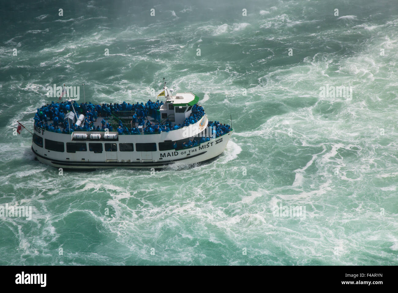 Looking down on Maid of the Mist tour boat on turbulent water Niagara River Stock Photo
