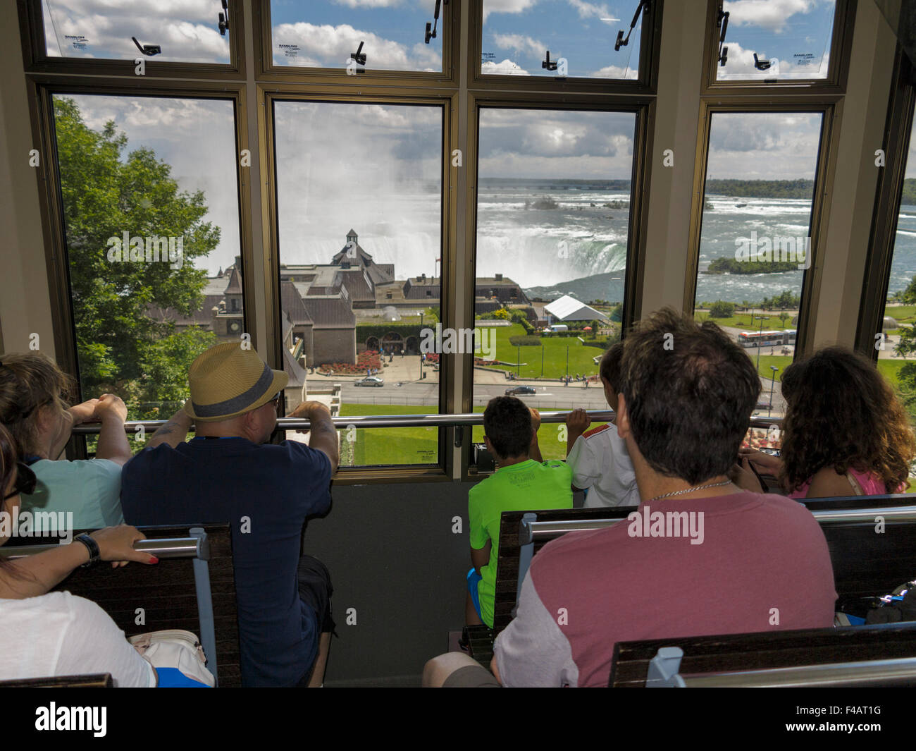Tourist enjoying the view through the windows of the Falls Incline Railway Niagara Falls Ontario Canada Stock Photo
