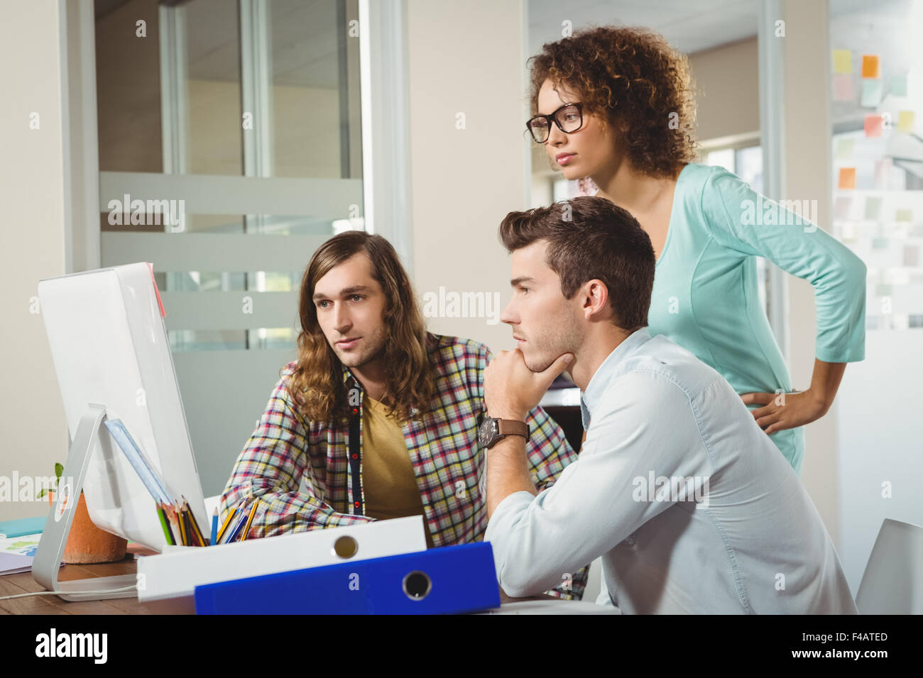 Business people looking at computer monitor Stock Photo