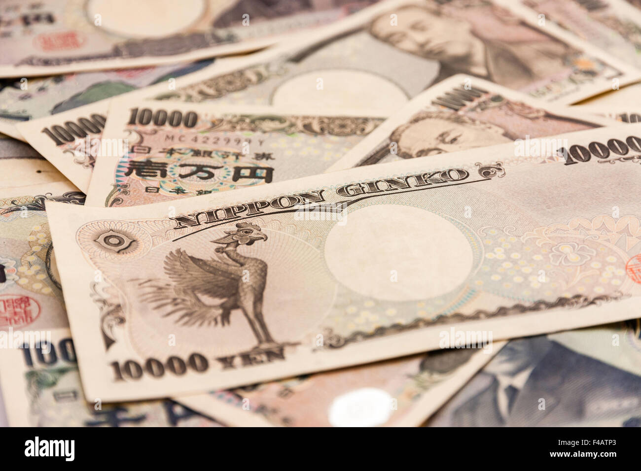 Japanese bank notes scattered in pile. Mostly 10,000 Yen notes with some 5000 yen notes. Close up. Stock Photo