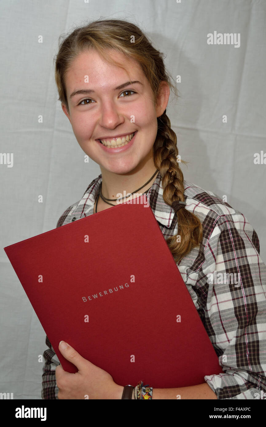 Smiling teenagers with application documents Stock Photo