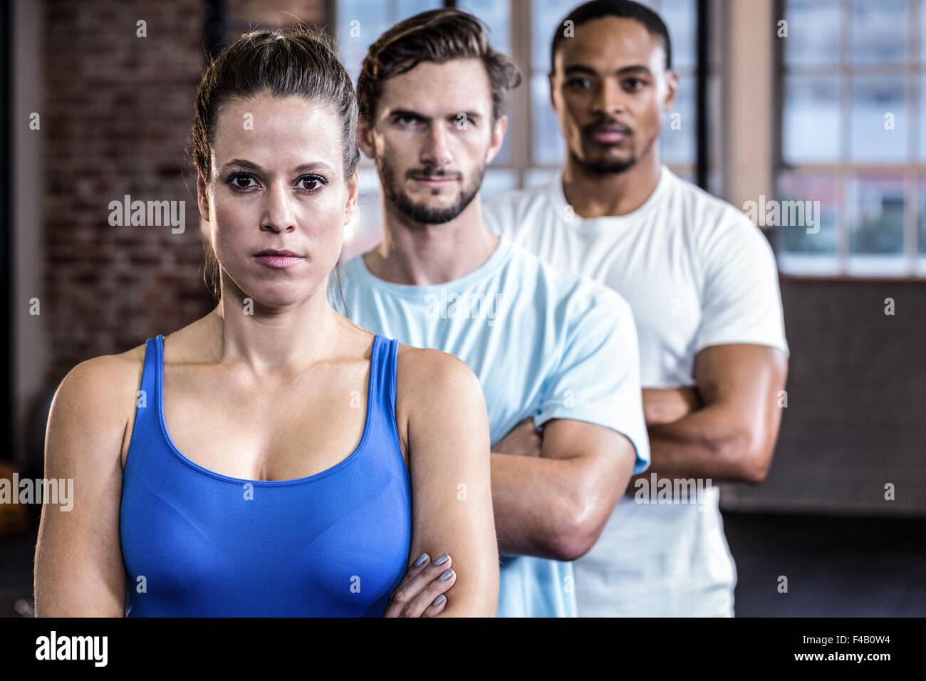 Three muscular athletes with crossed arms Stock Photo