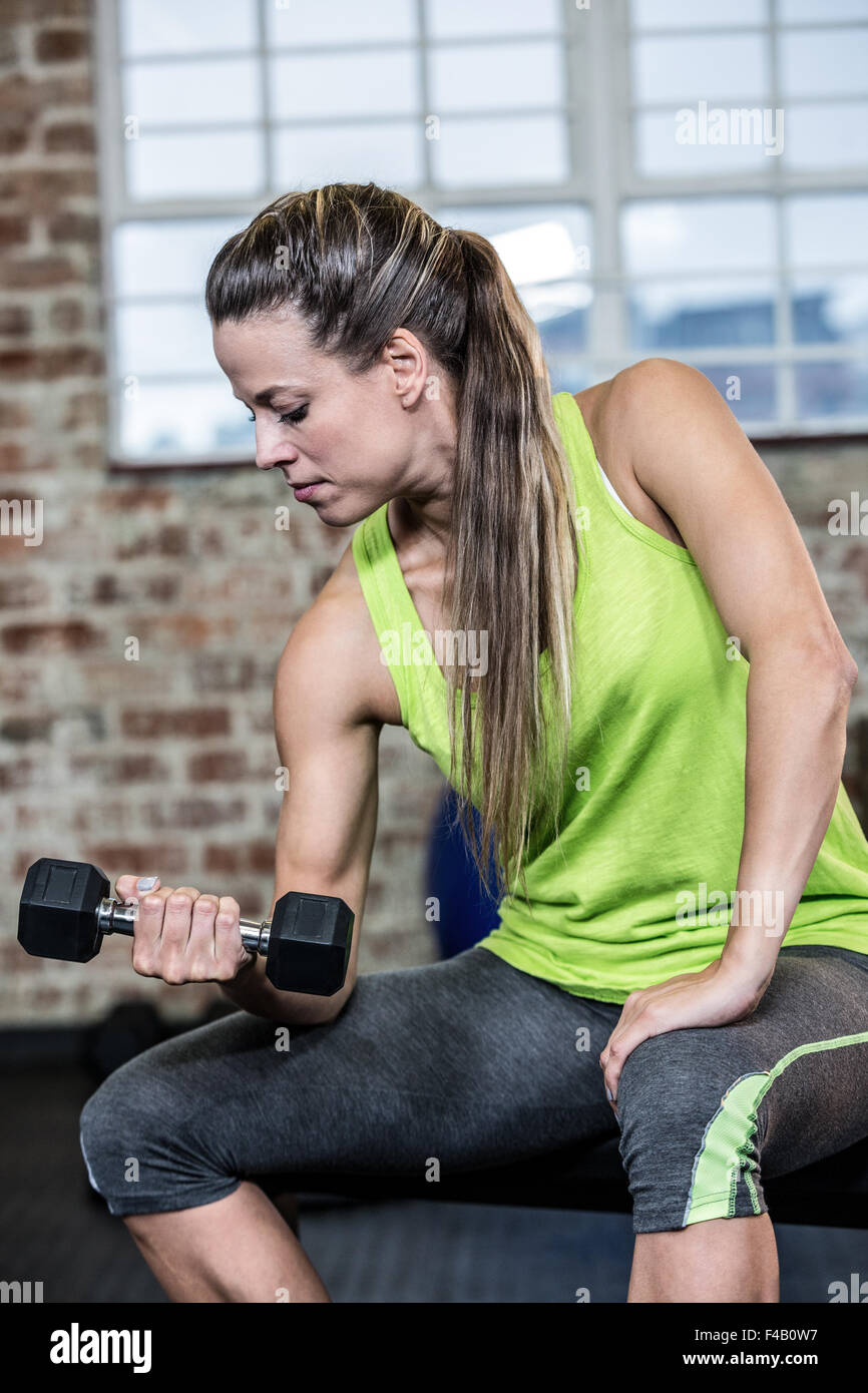 Fit woman lifting black dumbbell Stock Photo