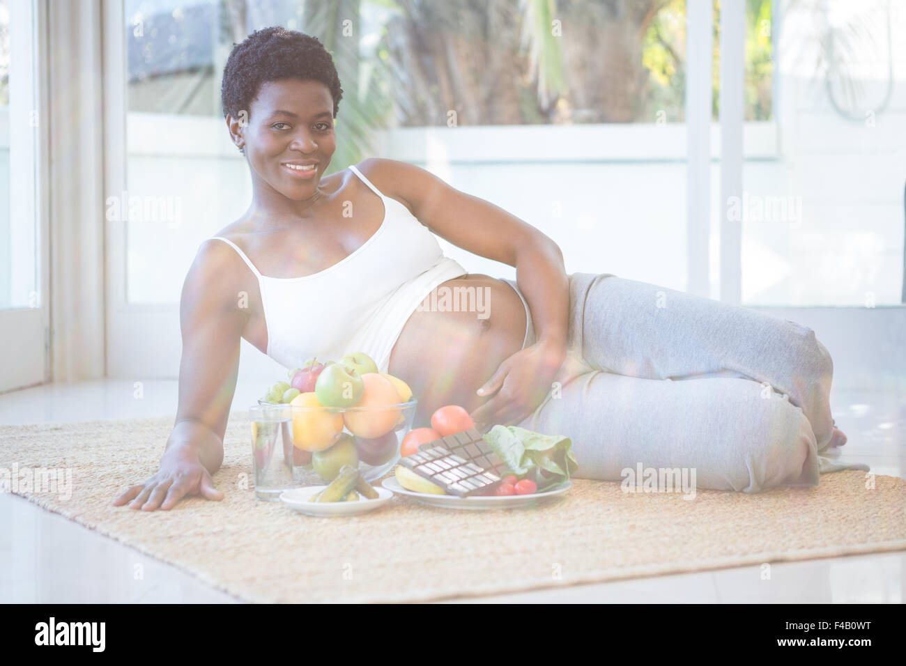 Woman lying down to enjoy some snacks Stock Photo