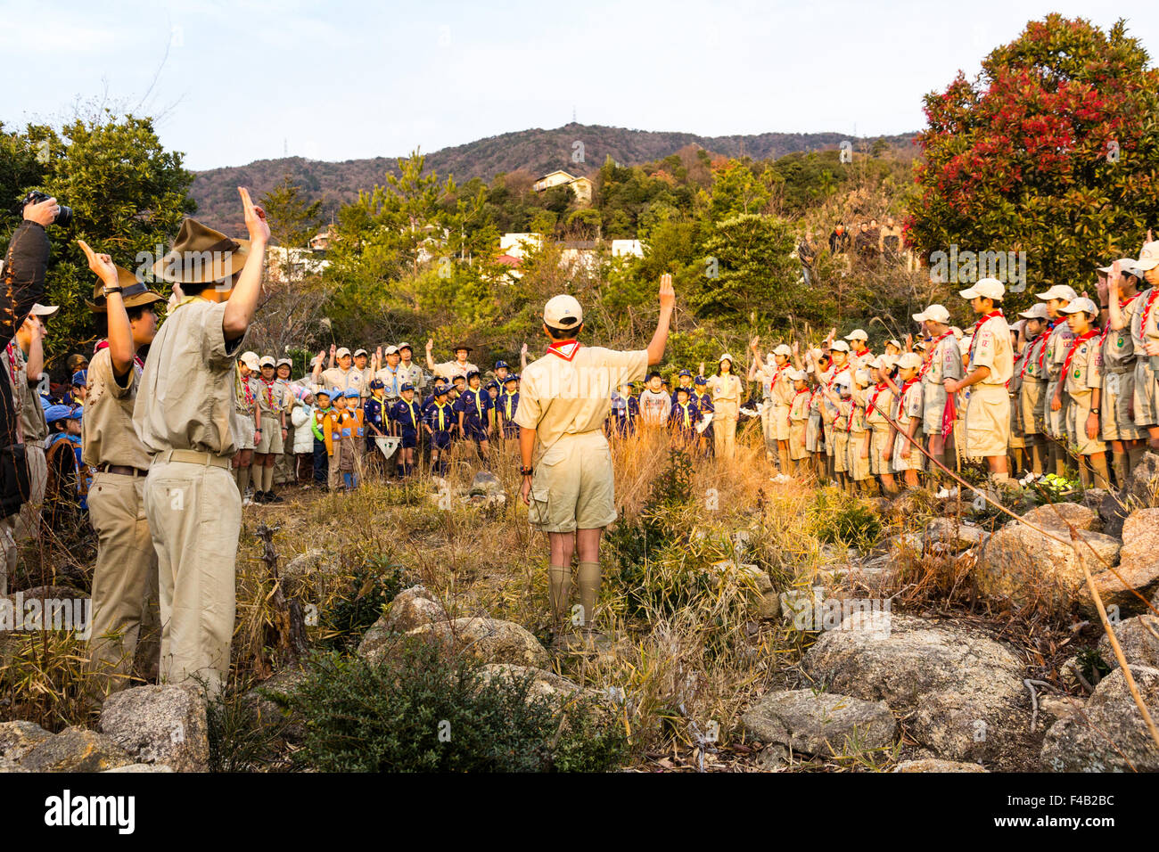 Japan. Boy scouts standing on mountain, saluting and making pledges