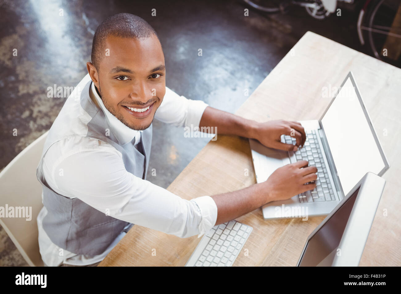 Smiling businessman working at office Stock Photo