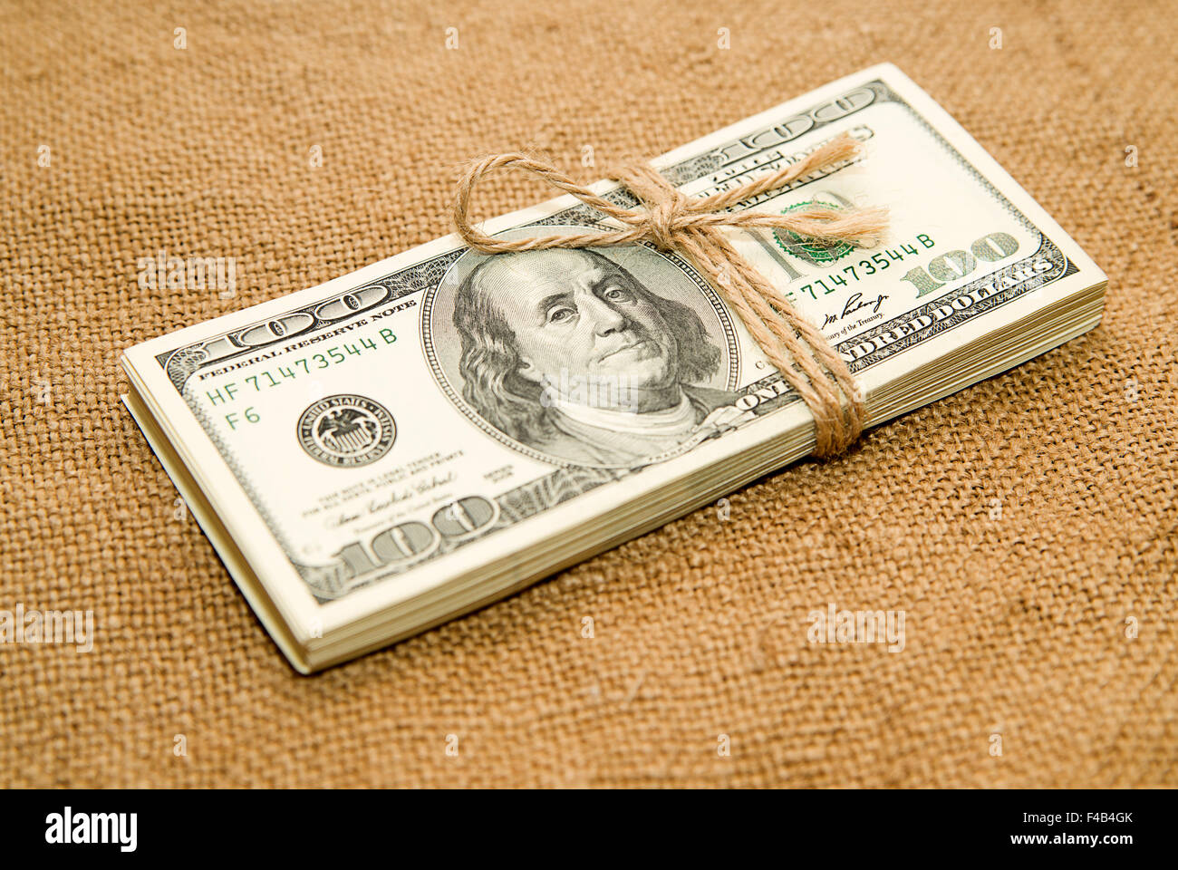 One pack of dollars tied up with rope on the old cloth Stock Photo