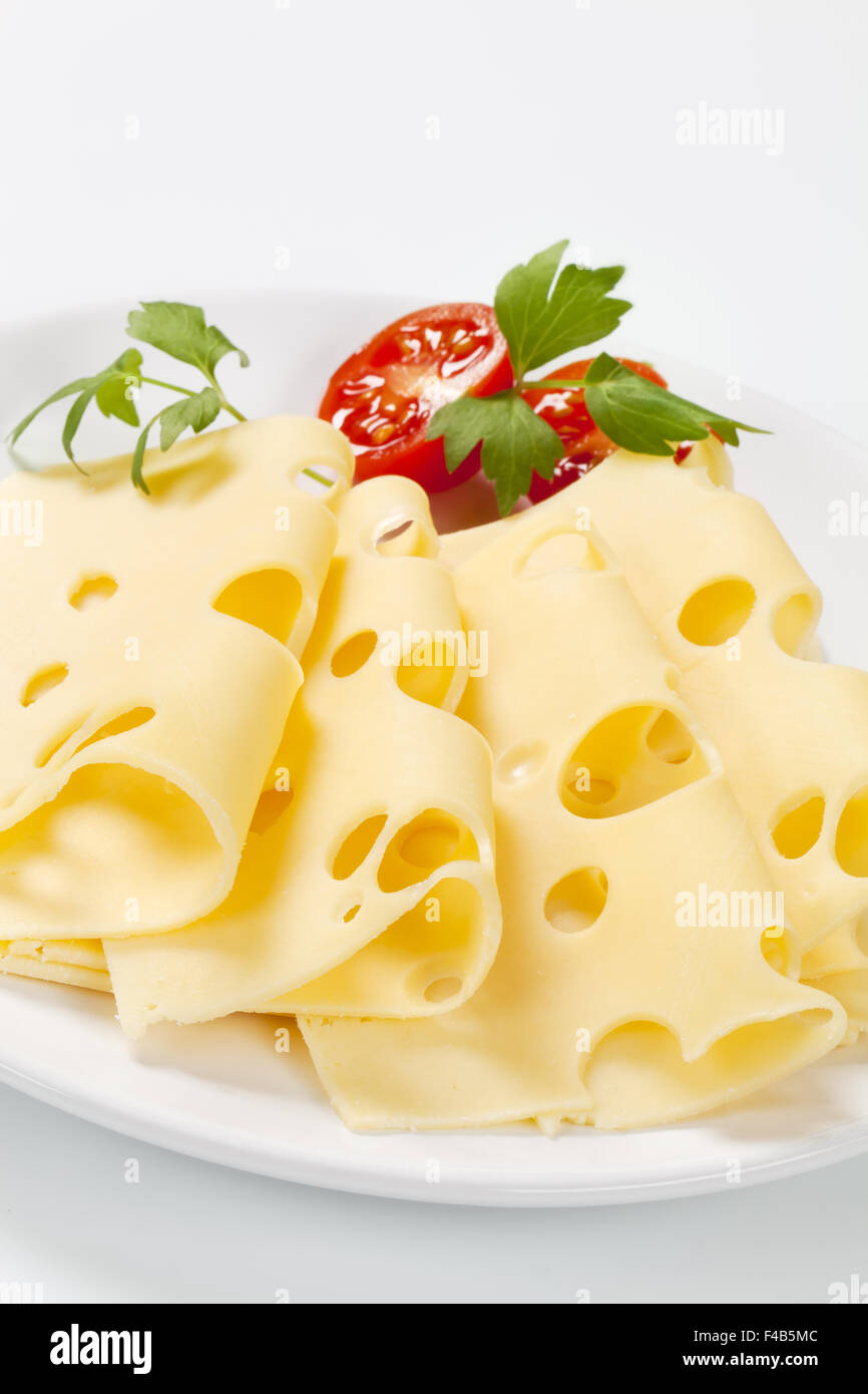 thin slices of emmental cheese on white plate Stock Photo Alamy