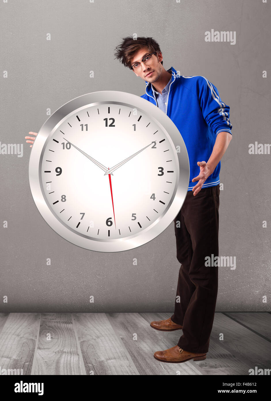 Attractive boy holding a huge clock Stock Photo - Alamy