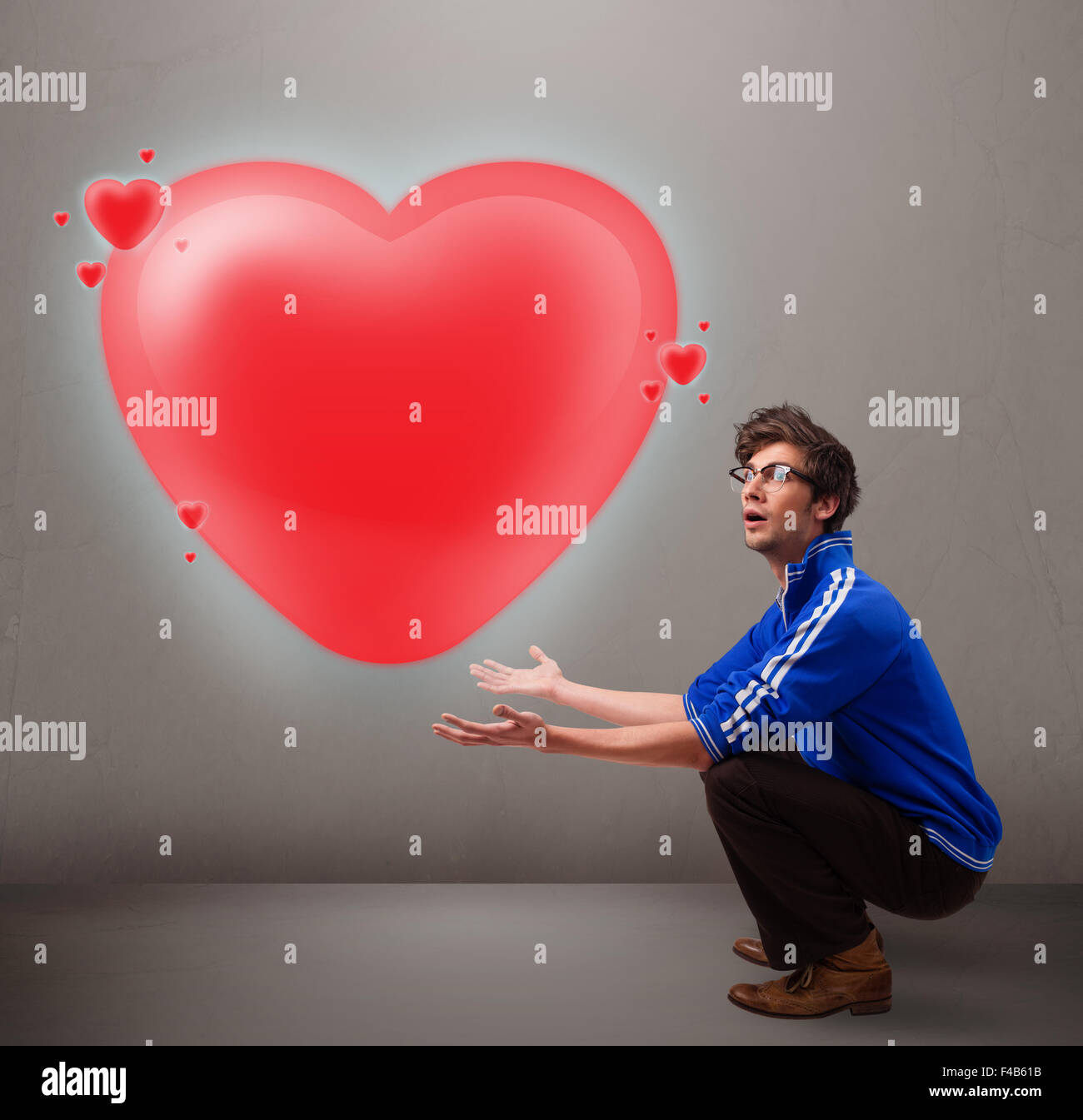 Young man holding lovely 3d red heart Stock Photo - Alamy