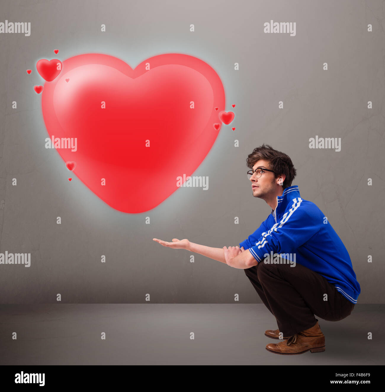 Young man holding lovely 3d red heart Stock Photo - Alamy
