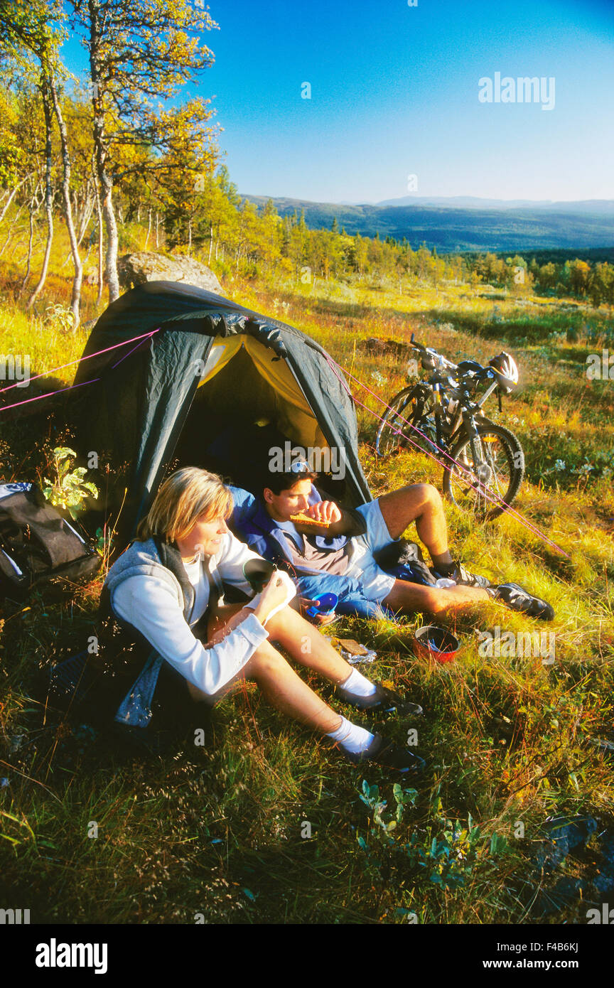 20-24 years 30-34 years activity adults only Are bicycle camping catalogue 2 color image ecotourism freedom to roam holiday Stock Photo