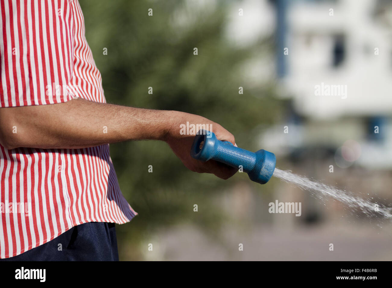 Water hose nozzle in the hand Stock Photo
