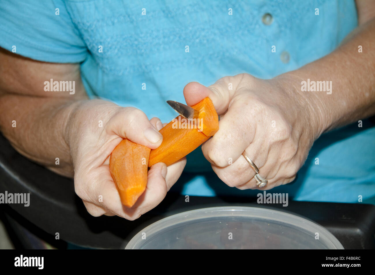 Carrot in the hand to cut Stock Photo