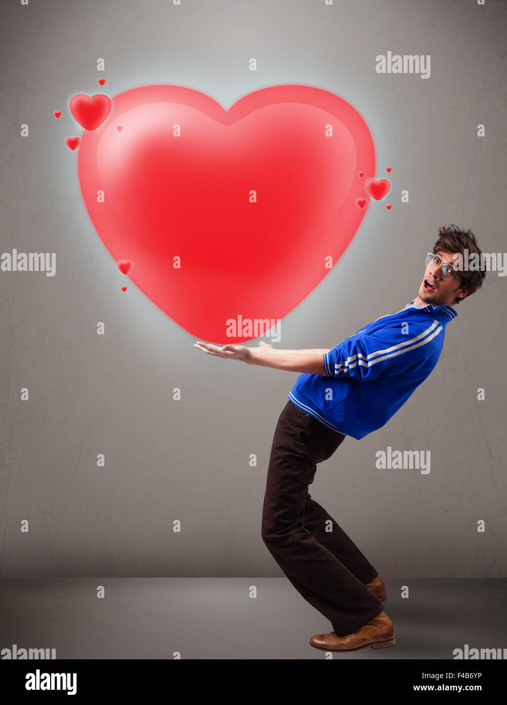 Young man holding lovely 3d red heart Stock Photo - Alamy