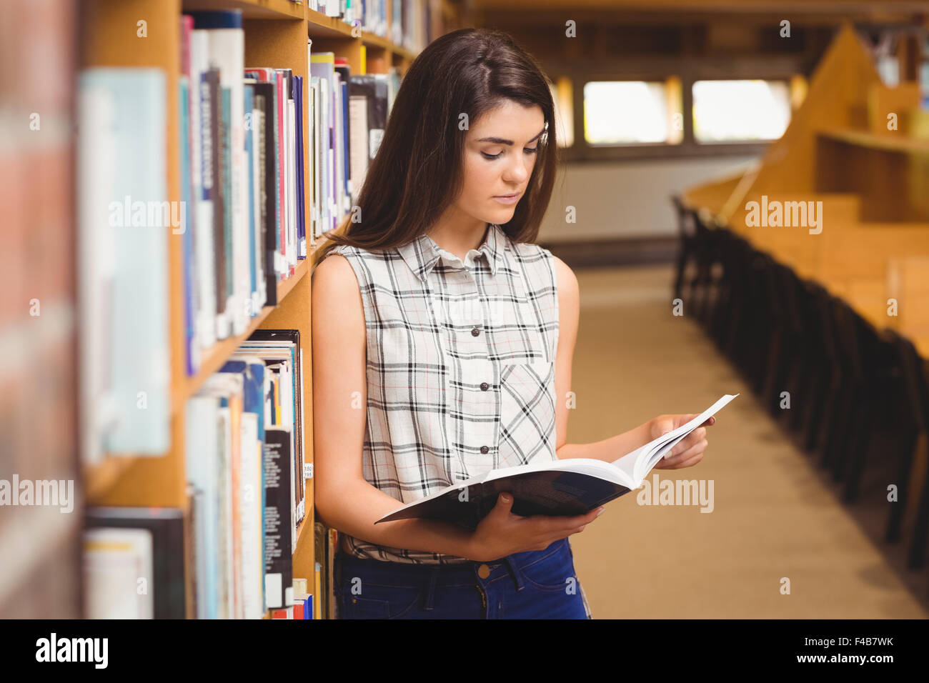 Female student learning from book Stock Photo