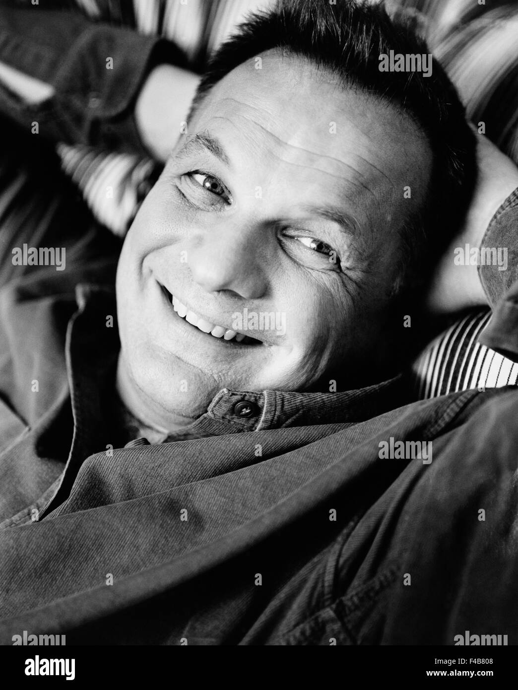 45-49 years adults only black and white catalogue 2 contentment face friendly happy indoors laughing lying man mature adult Stock Photo