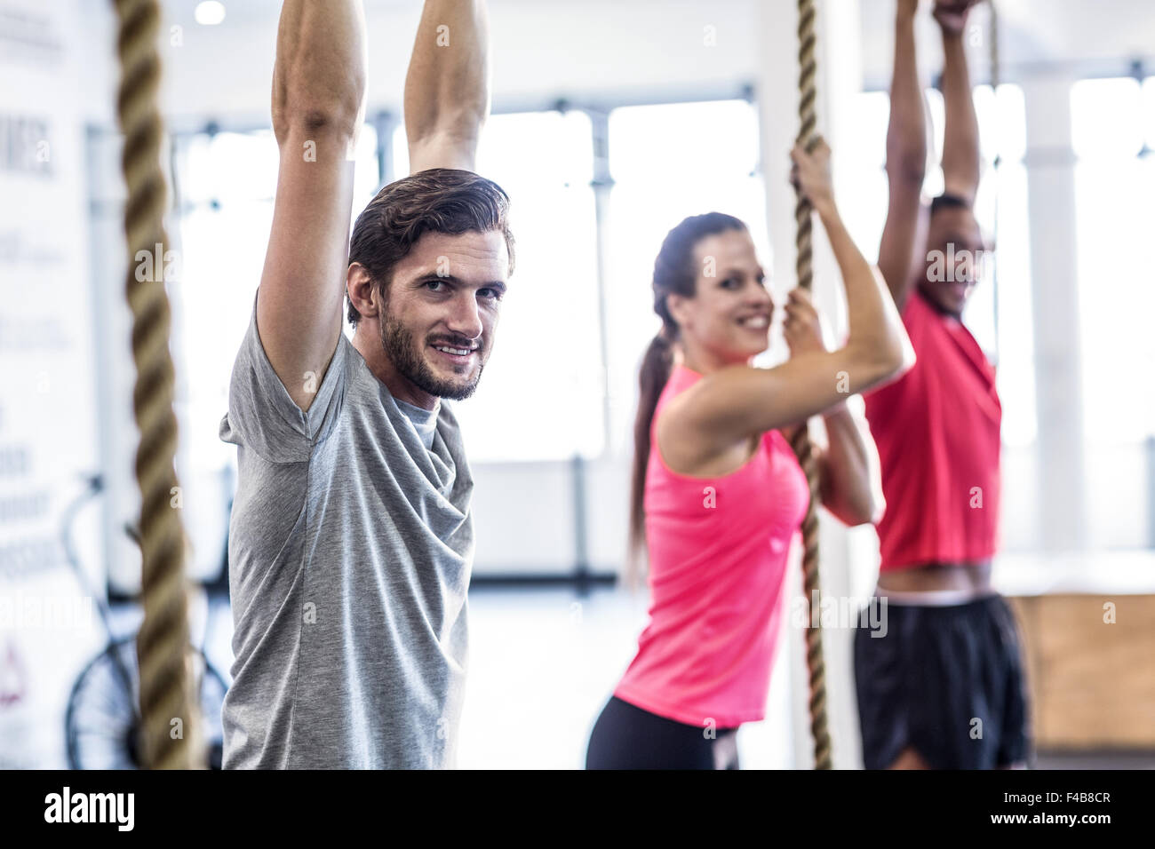 Athletes doing ring gymnastics and climbing rope Stock Photo Alamy
