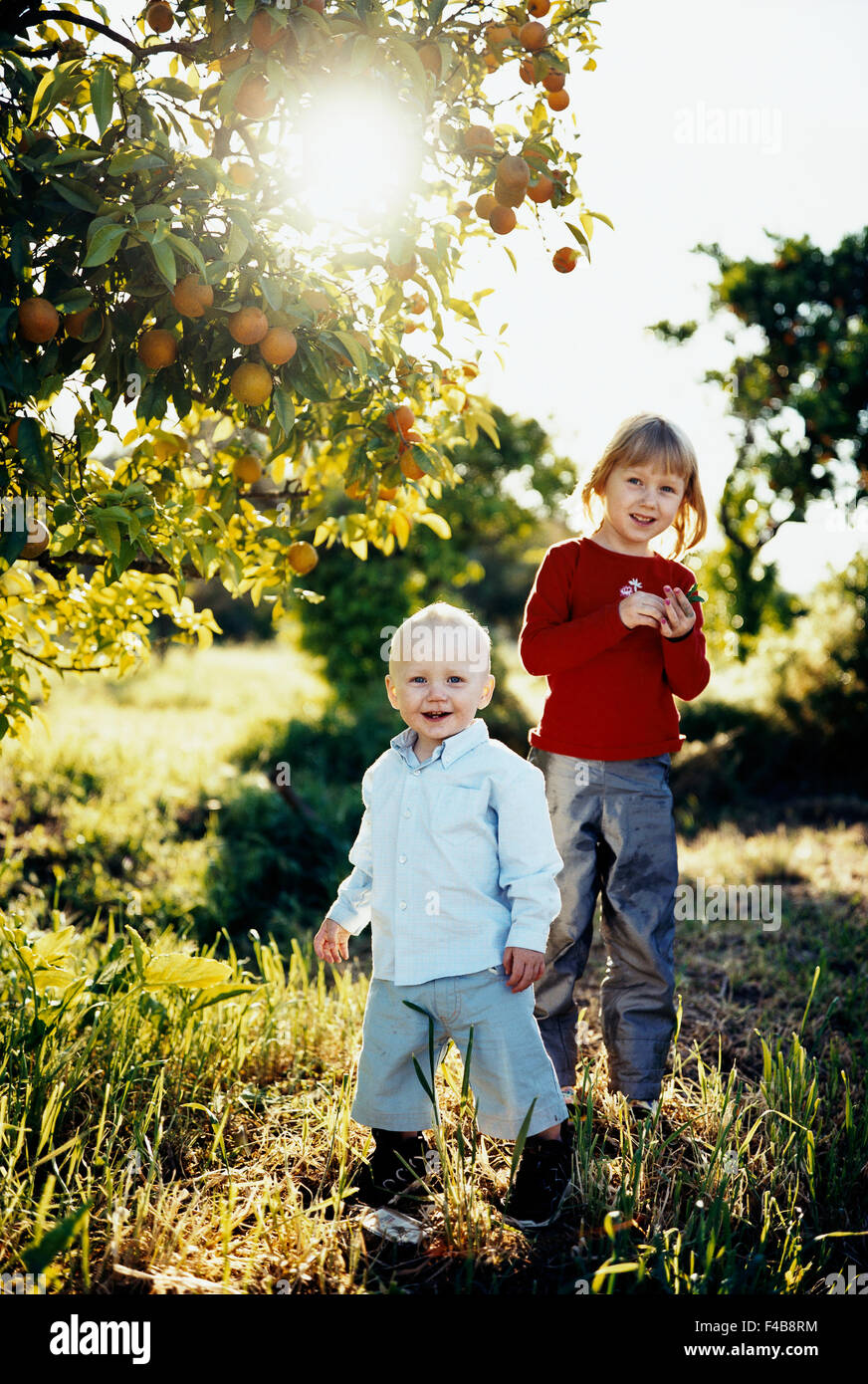 Boy girl standing back to back hi-res stock photography and images - Alamy