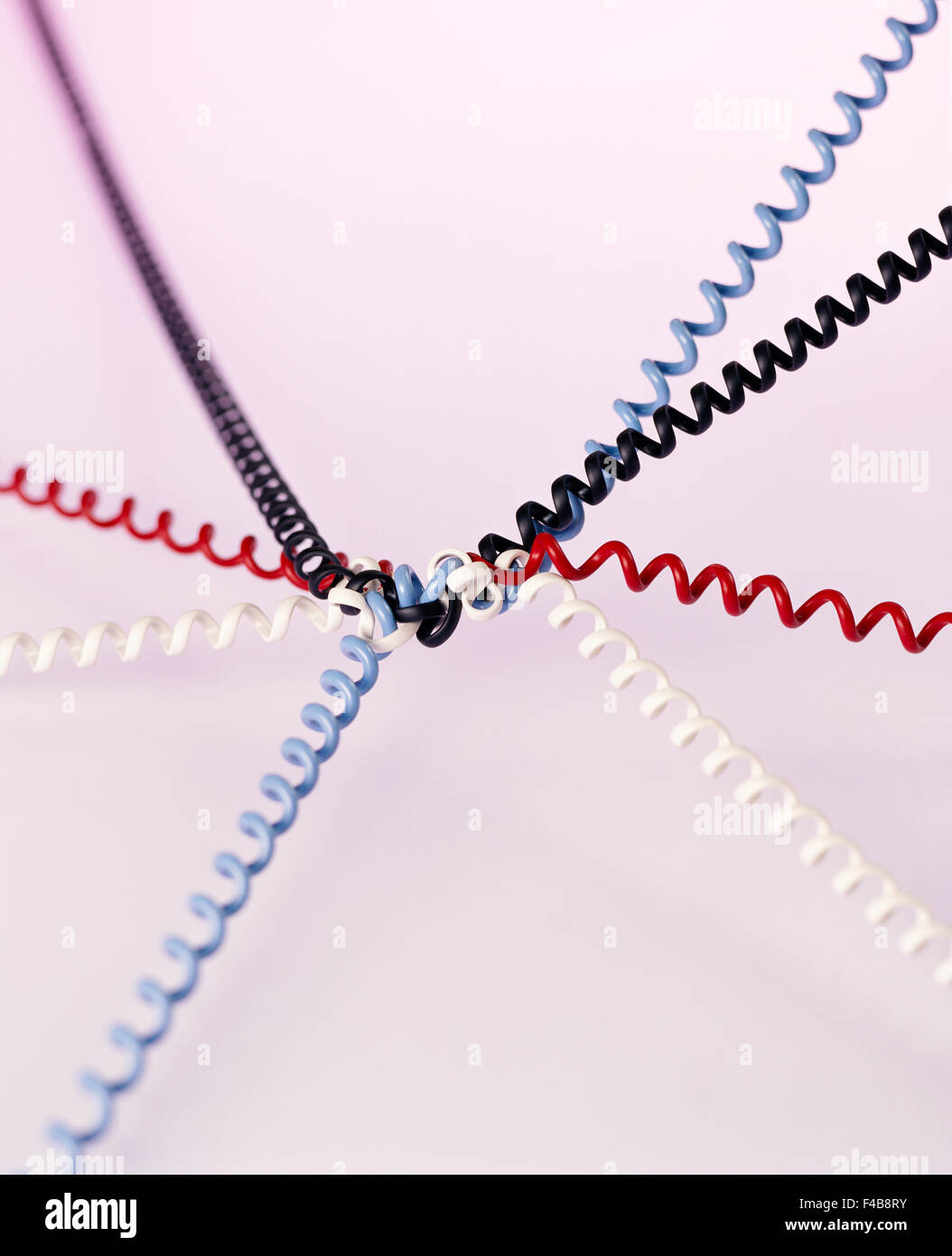 Closeup of telephone cords in different colors tangled. Stock Photo