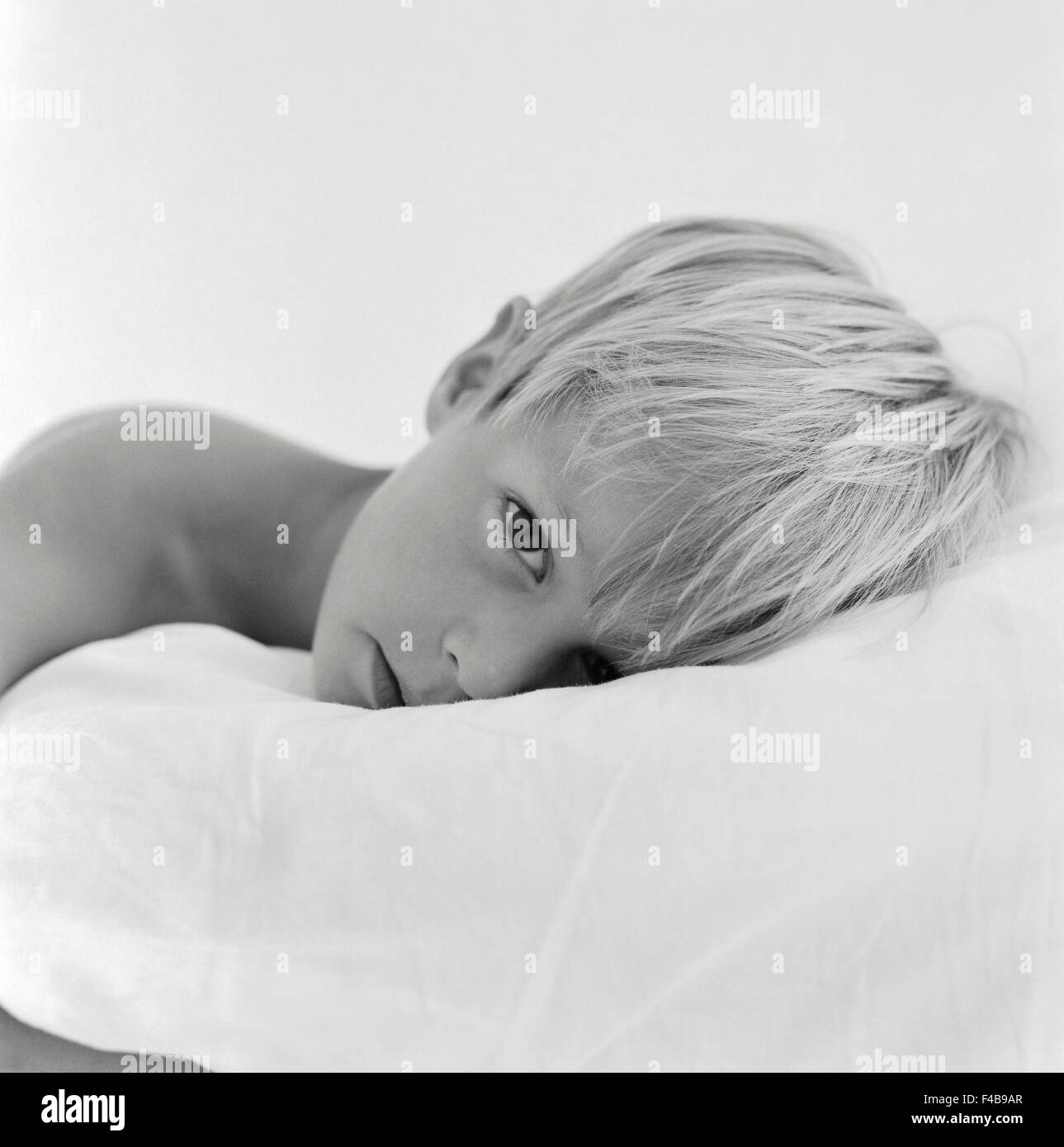 Boy with head on pillow and resting Stock Photo Alamy