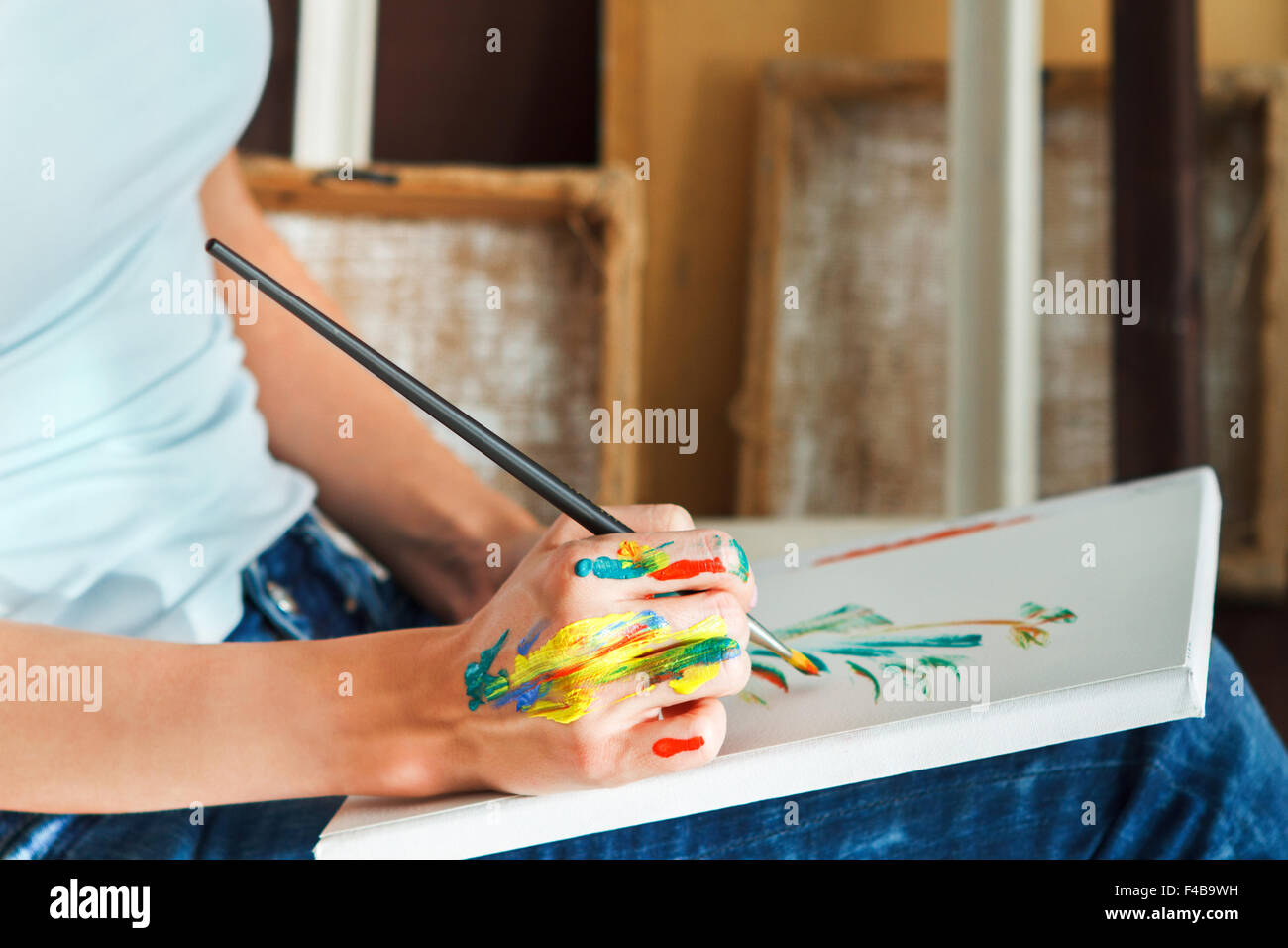 Female artist hand holding paintbrush Stock Photo - Alamy