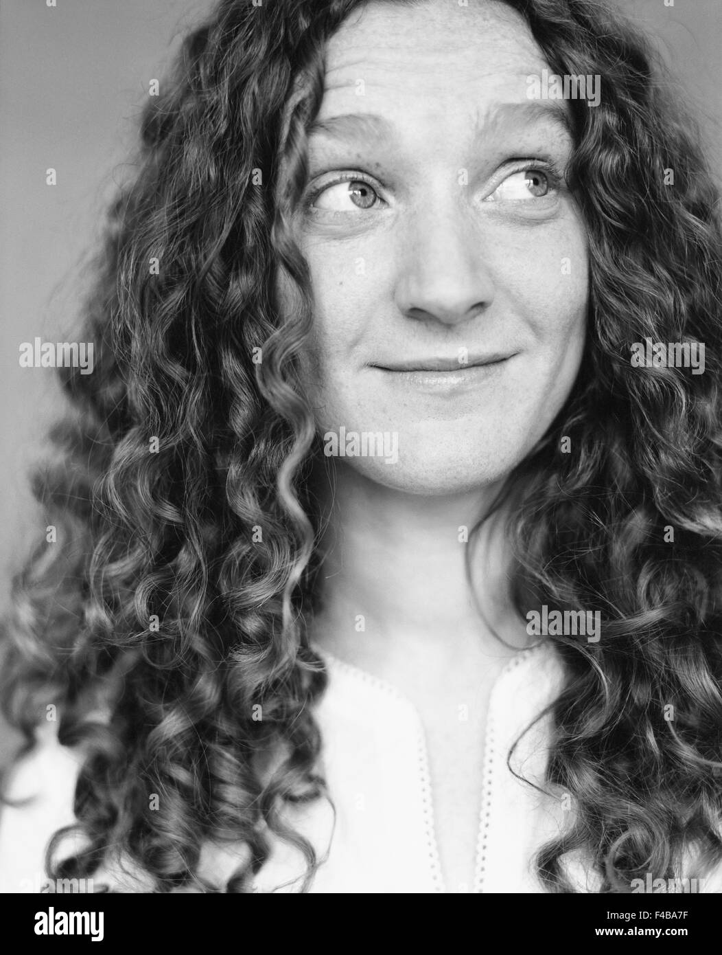 30-34 years adults only black and white catalogue 2 curly hair emotional series expression friendly glance happy indoors long Stock Photo