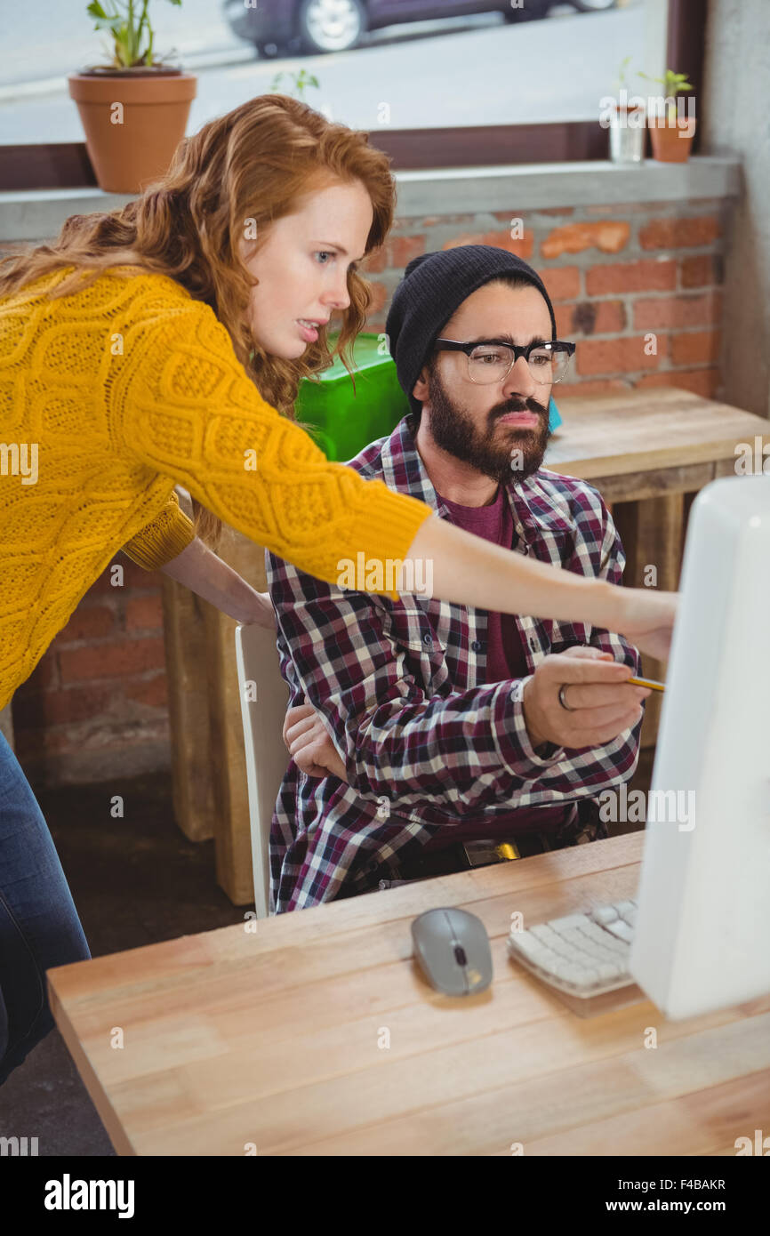 Woman pointing at computer and discussing Stock Photo