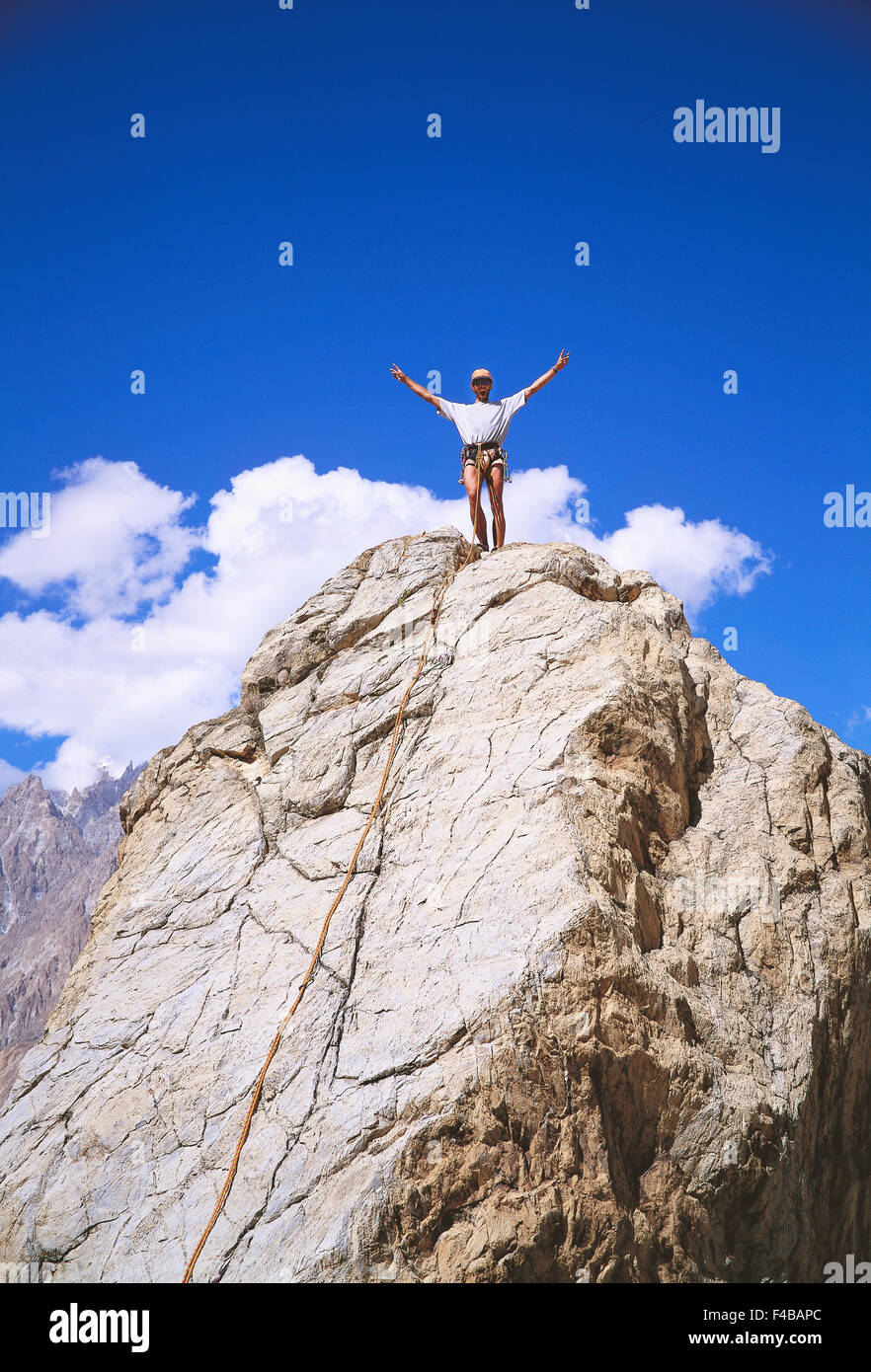 Mountain climbers cheering on a mountain top. Stock Photo