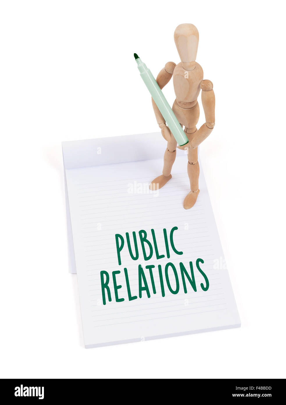 Wooden mannequin writing in a scrapbook - Public relations Stock Photo