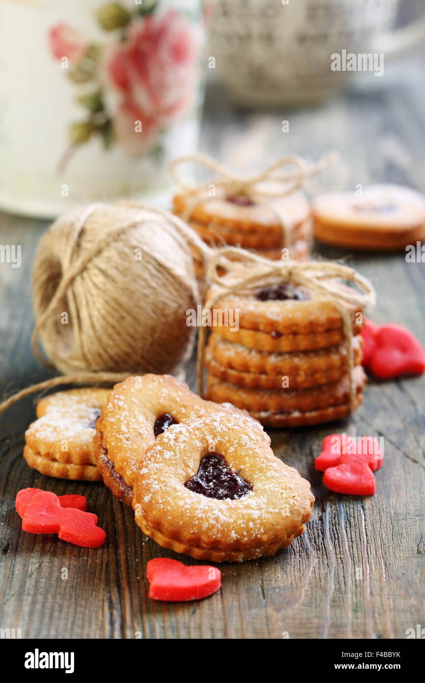 Red hearts marzipan and Linzer Cookie. Stock Photo