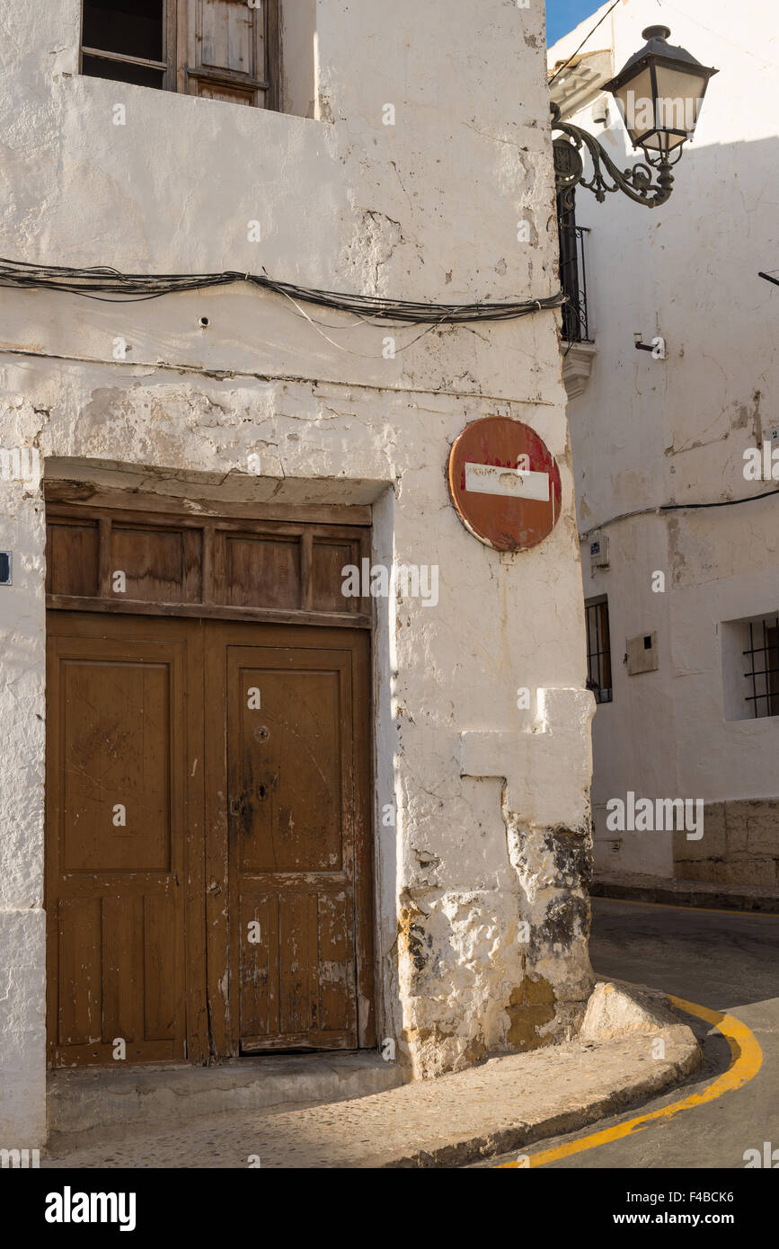 Whitewashed facades and old street lights and traffic signs in Altea ...